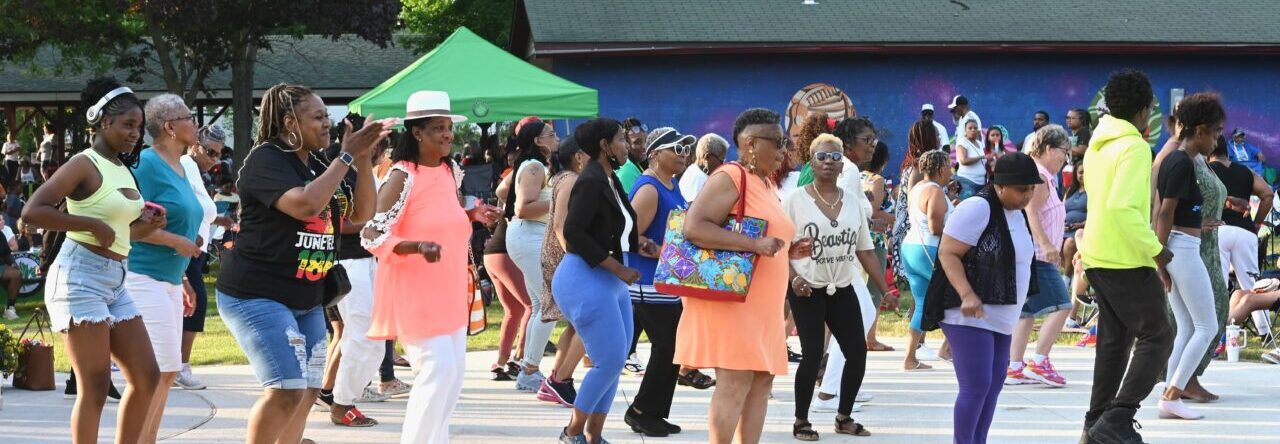 group of people dancing at neighborhood event